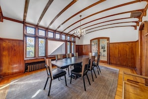 Dining Room original stained lead glass windows, wood paneling & arched ceilings