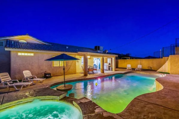 Nighttime photo - play pool oasis in full effect! Color changing pool lights, shallow end of pool, deep end of pool, hot tub, ultimate backyard!