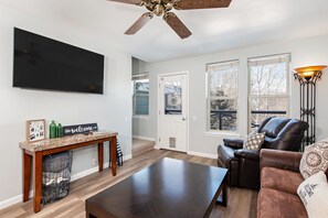 Living room with queen pull out sofa, SmartTV and deck access
