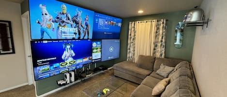 Gaming wall with 4-70” Samsung tvs, 2 Xbox series s, Nintendo switch, ps4
