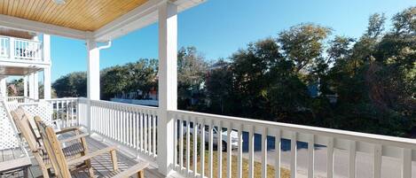 Relax on the large porch with a beverage after a long day at the beach