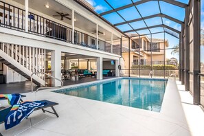 The two-story screened lanai features a heated pool (complimentary heat provided Nov 20-Apr 30).