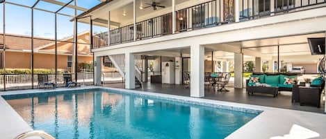 The Old Florida style home is all open on the ground level for entertaining and enjoying the pool with the living areas on the second and third levels