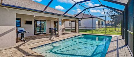 A Smart TV with Roku streaming is mounted on the lanai wall; a favorite with the kids while they play in the pool.