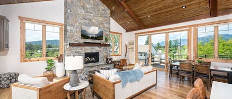 The beautiful wood-inlaid peaked ceiling beautifully frames the open concept living area of the home.