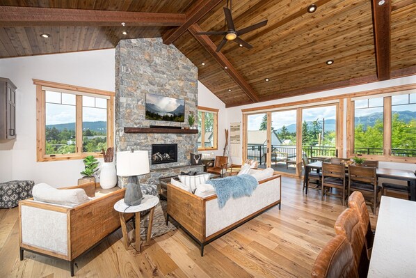 The beautiful wood-inlaid peaked ceiling beautifully frames the open concept living area of the home.