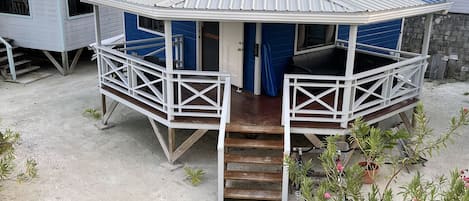 Exterior view of Moody Blue cottage showing rap around porch and courtesy bikes