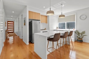 Looking too front door from open plan living room