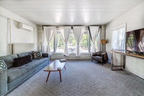 Gigantic windows overlooking backyard - black out curtains with linen draws.