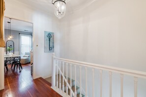 Upstairs leads to the kitchen and extra dining area with the living room around.