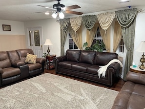 Comfortable family room with leather sofa bed and 55" smart TV