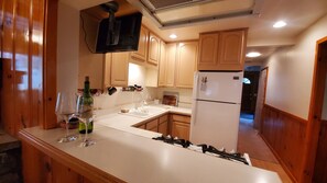 Kitchen with gas stove, oven refrigerator, bar seating