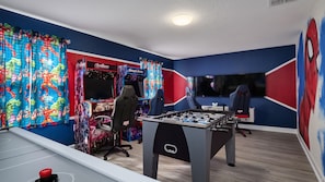 Fantastic Marvel Themed Game Room with Air Hockey, Foosball, Arcade Games and Flat Screen TV and more!