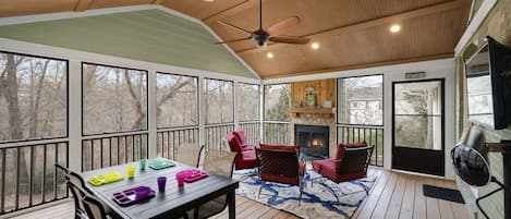 Screened in porch with electric patio heater, gas starter wood burning fireplace