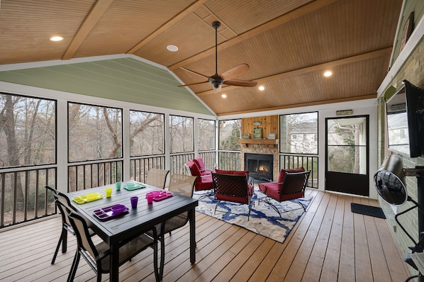 Screened in porch with electric patio heater, gas starter wood burning fireplace