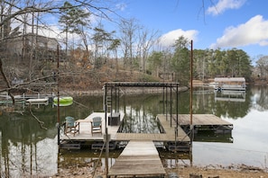 Covered single slip dock with attached floating swim dock. 