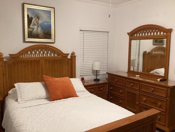 Picture yourself in this lovely bedroom adorned with a beautiful wall painting.