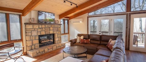 Living Room with Stone Fireplace, HD Smart TV, Comfy Leather Furniture