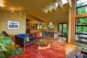 Living area with views of dining area and kitchen