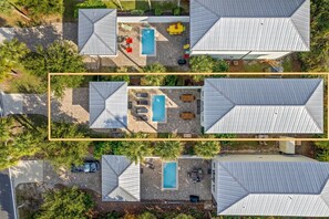 Aerial view of main house, splash pool, and coach house