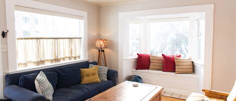 A super comfortable and Cozy Living room greets you as you enter the home with a bright bay window and window seat.