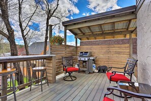 Private back deck with seating, granite bar, and gas grill—perfect for a BBQ.