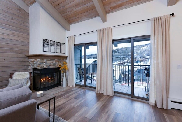 Wood burning fireplace and sliders leading to private balcony