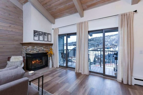 Wood burning fireplace and sliders leading to private balcony