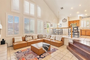 Living room opens to kitchen, with 30 foot cathedral ceilings.