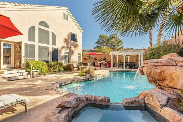 Back yard oasis with pool, hot tub, and plenty of lounging and dining space.