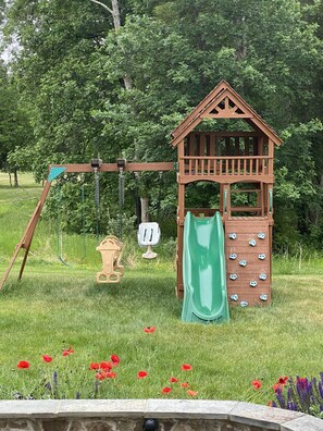 Playground - swings, slide, climbing wall.  Sandbox and playhouse not pictured