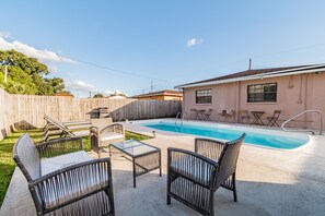 Large fenced in backyard with pool & ample outdoor seating