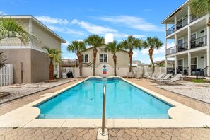 Pool which is shared with 3 other homes, nice large seating area out back