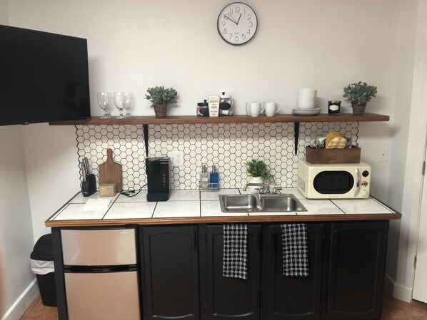 Kitchenette with microwave, refrigerator and toaster oven. 