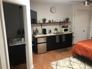 Kitchenette borders the beautiful bathroom.