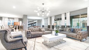 Bright, elegant living space with pool table and modern flair!