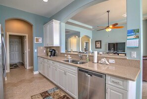 The Kitchen Has a Bar Height Counter and Easy Access to the Family Room and Laundry Room