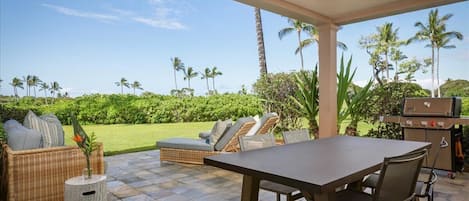 Spacious and well appointed lanai with BBQ grill opens to a gorgeous lawn and manicured fairways.