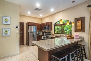 The kitchen features bar seats for 4, stainless appliances, herbs & spices, +!