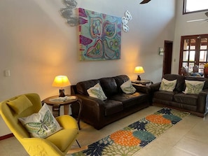 Living room with large smart TV and original art 