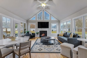 Enjoy a Living Room with plentiful windows and natural light! Vaulted ceilings and the warm glow of the gas fireplace will set the mood. Log into your favorite streaming apps on a 75” Roku HDTV.