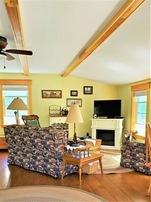 Sitting room with Sofa, armchair and electric fireplace. Flat screen TV.