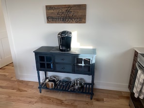 Coffee station with Keurig coffee machine.  Stocked with starter supplies.