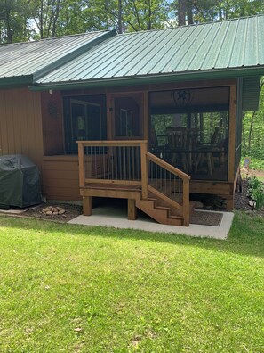 Back entry to screen porch and access to grill and bonfire area.