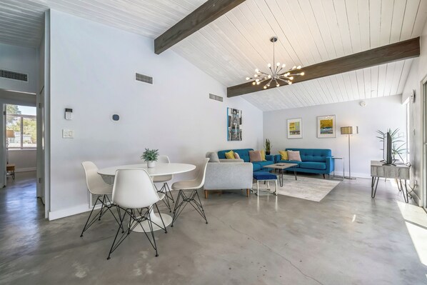 Living room and breakfast area look out to the pool and backyard
