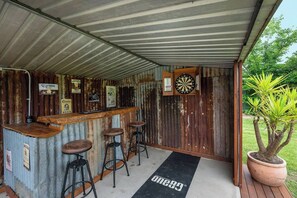 Enjoy outdoor gathering with friends and family in the converted bar with a dartboard.