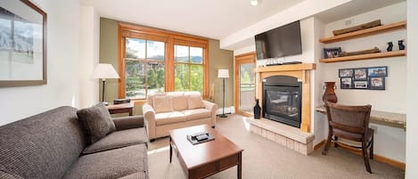 Living Room with Gas Fireplace, Mountain Views, and Remote Work Desk Space