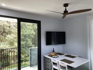 Dining room with flexible table on easy to move wheels which comfortably seats 4