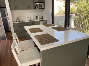 New kitchen with full size top of the range appliances