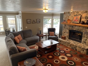 Enjoy the open floor plan living area with plenty of seating and a fireplace.